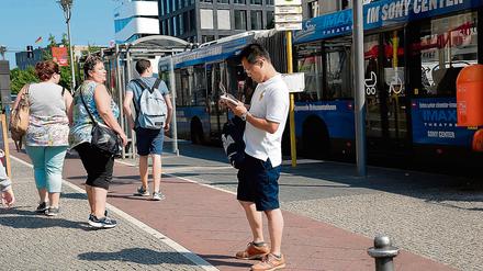 Touristen stehen aus Unwissenheit auf dem Radweg am Potsdamer Platz - Ecke Leipziger Straße in Berlin-Mitte.