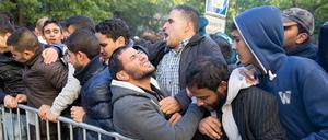 Flüchtlinge in Berlin auf dem Gelände des Landesamtes für Gesundheit und Soziales (LaGeSo) an einem Absperrgitter. Experten sehen in der Ansammlung vieler Menschen auf engem Raum eine Ursache für Aggressionen.