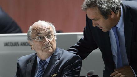 FILES - A picture taken on May 29, 2015 shows FIFA President Sepp Blatter (L) listening to UEFA President Michel Platini during the 65th FIFA Congress in Zurich. Embattled FIFA chief Joseph Blatter is suspected of "disloyal payment" to UEFA head Michel Platini, who had hoped to succeed him, the office of Switzerland's attorney general said on September 25, 2015. AFP PHOTO / FABRICE COFFRINI