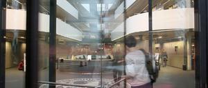 Blick durch eine Drehtür in eine Bibliothek.