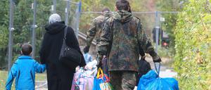 Ein Bundeswehrsoldat hilft Flüchtlingen aus Syrien beim Tragen ihrer Habseligkeiten vor der Flüchtlingsunterkunft in Gera. Die Bundesregierung überlegt, die Soldaten künftig auch für Abschiebungen einzusetzen.  