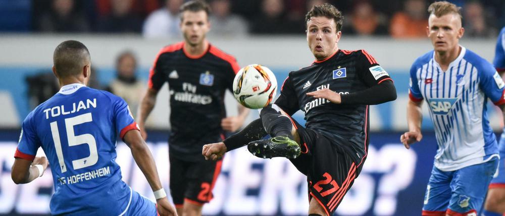 Hoffenheims Jeremy Toljan (l) und Hamburgs Nicolai Müller kämpfen um den Ball.