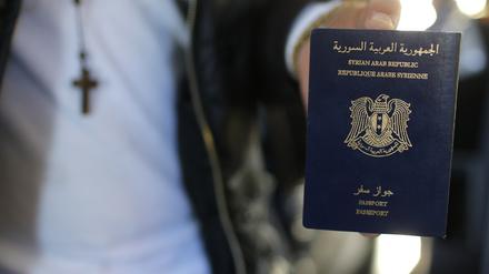 Ein syrischer Flüchtling zeigt seinen neuen Reisepass.