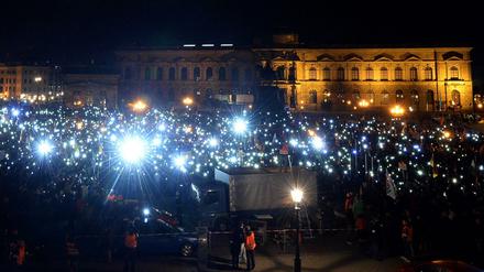 Anhänger der Pegida (Patriotische Europäer gegen die Islamisierung des Abendlandes) halten am 26.10.2015 in Dresden zum Abschluss ihrer Versammlung auf dem Theaterplatz ihre Handys hoch.