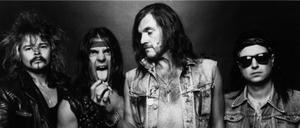 Phil Taylor (l.) mit den anderen Motörhead-Bandmitgliedern Michael Burston, Lemmy Kilminster und Phil Campbell auf einer Aufnahme von 1985.