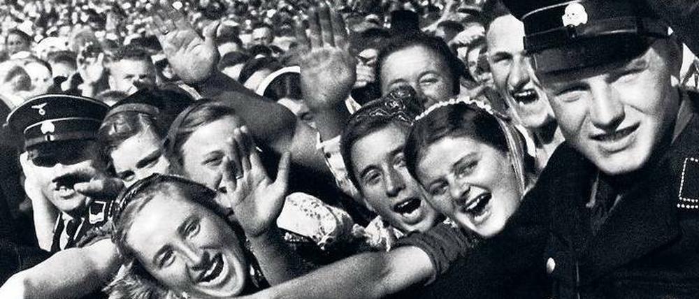 Zehntausende können irren. Vertreter der „Volksgemeinschaft“ bejubeln Hitler beim „Reichserntedankfest“ am Bückeberg, vermutlich am 6. Oktober 1935, von SS-Männern mit Toten-Kopf-Mützen in Schach gehalten.