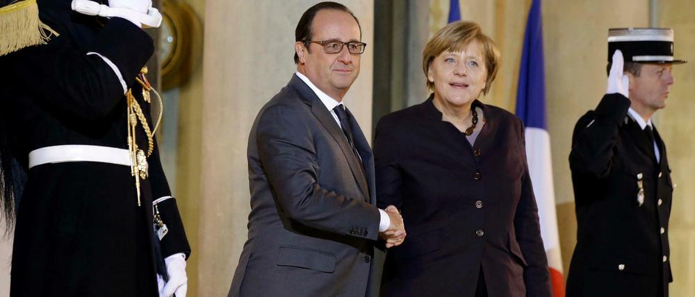 Handschlag. Bundeskanzlerin Angela Merkel wird am Mittwochabend von Frankreichs Präsident Francois Hollande im Elysee-Palast empfangen.