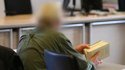 Klaus H. hält am 16.11.2015 im Amtsgericht Nördlingen (Bayern) während einer Verhandlungspause ein Gesetzbuch in seinen Händen. Das 54-jährige Mitglied der Glaubensgemeinschaft "Zwölf Stämme" ist der Misshandlung von Schutzbefohlenen und gefährlicher Körperverletzung angeklagt.