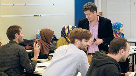 Hamed Al-Drubi (stehend) bietet am Sprachenzentrum der Freien Universität Arabischkurse für Flüchtlingshelfer an. 