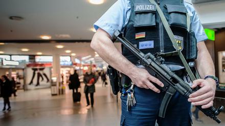 Ein bewaffneter Polizist steht am 18.11.2015 in Berlin im Flughafen Tegel. Nach den Terroranschlägen von Paris wurden die Sicherheitsvorkehrungen auf öffentlichen Plätzen und in bestimmten öffentlichen Gebäuden verstärkt. 