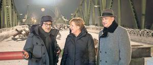 Auch Kanzlerin Angela Merkel hat ein Faible für Drehorte, wie sie beim Besuch auf der Glienicker Brücke am Set von Steven Spielbergs „Bridge of Spies“ zeigte. Tom Hanks (rechts) hat’s gefreut. 
