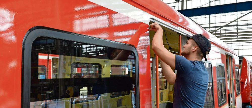 Ein Fahrzeugmonteur arbeitet in Hennigsdorf an einer S-Bahn vom Typ 430. Mehr als 2800 Mitarbeiter produzieren an diesem Standort unter anderem S-Bahnen und Straßenbahnen. 