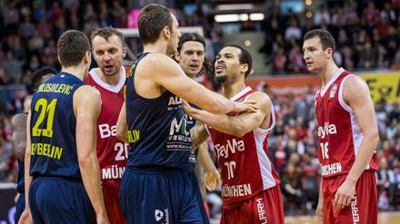 Justin Cobbs (2.v.r) von München und Elmedin Kikanovic (3.v.l) von Alba Berlin geraten aneinander.
