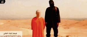 Vorsicht geboten. Screenshot eines Videos, das von der Terrormiliz Islamischer Staat (IS) aufgenommen worden sein soll und angeblich die Enthauptung des US-Fotografen James Foley zeigt. 