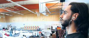 Heimat im Notquartier. In der Turnhalle in der TU in Berlin lernt ein Flüchtling elektronisch Deutsch.