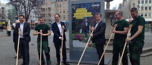 Zusammen mit Mitarbeitern des Gartenbauamts wollen Sebastian Brand von der BSR, Patrick Möller vom Vorstand der Wall AG und Bezirksbürgermeister Frank Balzer Bürger zum Mitputzen motivieren.