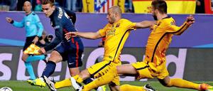 Antoine Griezmann (Links) gegen Barcelonas Verteidiger Gerard Pique (Rechts) und Javier Mascherano (Mitte)