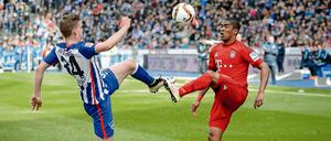 Berlins Maximilian Mittelstädt (links) hält das Beinniveau von Münchens Douglas Costa.