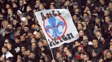 ARCHIV - Fußball Bundesliga 15. Spieltag: Eintracht Frankfurt - SV Darmstadt 98 am 06.12.2015 in Frankfurt am Main (Hessen). Die Frankfurter Ultras schwenken eine Fahne mit der Aufschrift «Anti Lilien». 