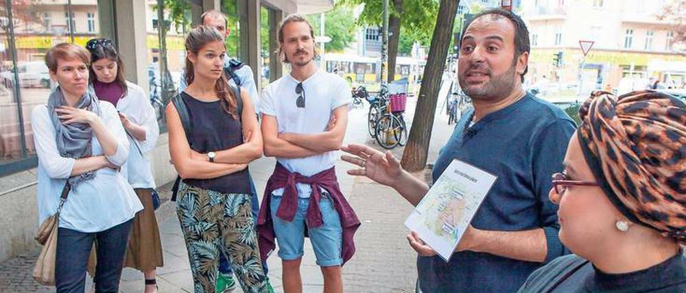 Zur Orientierung. Die Stadtführer Samer Serawan (2. v. r.) und seine Frau Arij (r.) zeigen auf Karten, wie sie nach Deutschland kamen.
