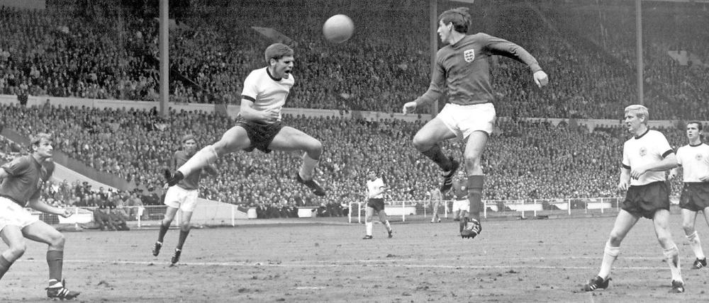 Martin Peters justs fails to get to a cross that is headed away by Wolfgang Weber.