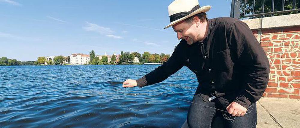Phillip Geist versenkt seine Kamera nahe der Mündung von Müggelspree und Dahme.