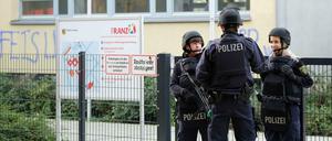 Polizisten stehen in Leipzig vor dem Reclam-Gymnasium. Per E-Mail sind zuvor an mindestens sieben Schulen in Leipzig Drohungen eingegangen.