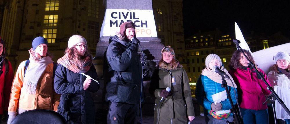Teilnehmer des Friedensmarsch stehen nach ihrer Ankunft vor der Frauenkirche in Dresden. Mittlerweile sind die Läufer in Tschechien.