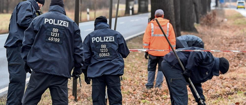 Einsatzkräfte der Polizei suchen am einen Tatort in Oegeln im Landkreis Oder-Spree (Brandenburg) nach Spuren ab.