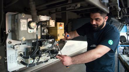 Der Syrer Saadi aus der Qualifizierungsklasse für junge Flüchtlinge der Deutschen Bahn arbeitet in Berlin im Werk Schöneweide der S-Bahn an der Elektronik-Komponente einer Bremsgeräteeinheit. 