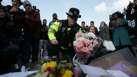 Stilles Gedenken. Eine Polizistin legt Blumen am Tatort nieder.