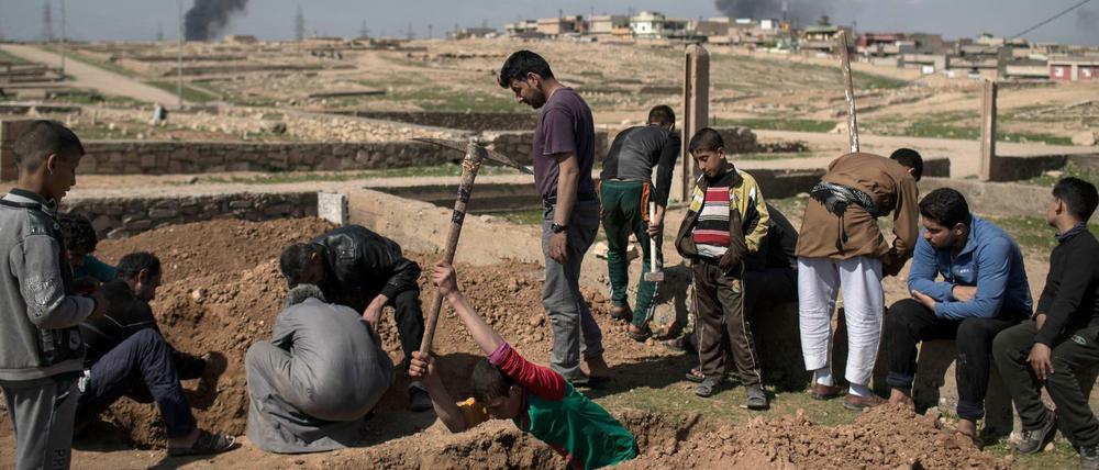 Freunde und Verwandte des Opfers nehmen in Mossul (Irak) an der Beerdigung teil.