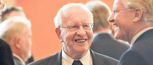 Ein älterer Mann ist im Gespräch mit anderen älteren Männern zu sehen.