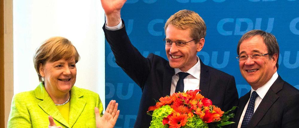 Applaus von der Parteichefin. Und der Wahlsieger Daniel Günther (M.) strahlt - ebenso wie der CDU-Spitzenkandidat für NRW, Armin Laschet.