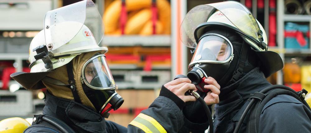 Zwei Feuerwehrmänner machen sich bereit für den Einsatz. Symbolbild.