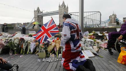 Ein Mann beim Gebet nahe der Tower Bridge in London.