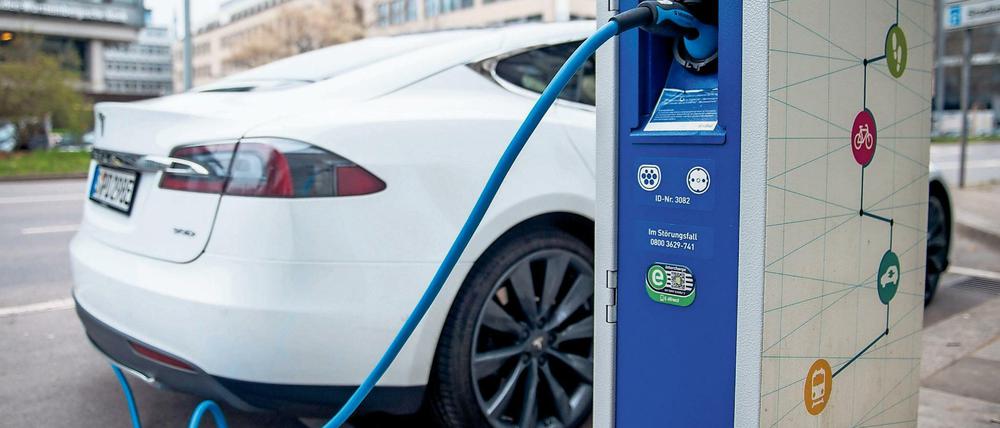 Ein Elektroauto des Typs Tesla S lädt in Stuttgart an einer Stromtankstelle.