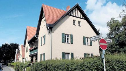 Sandfarbene Fassaden, flaschengrüne Fensterläden. Das Haus Buchenweg 3–4 wurde bereits saniert. 