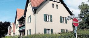 Sandfarbene Fassaden, flaschengrüne Fensterläden. Das Haus Buchenweg 3–4 wurde bereits saniert. 