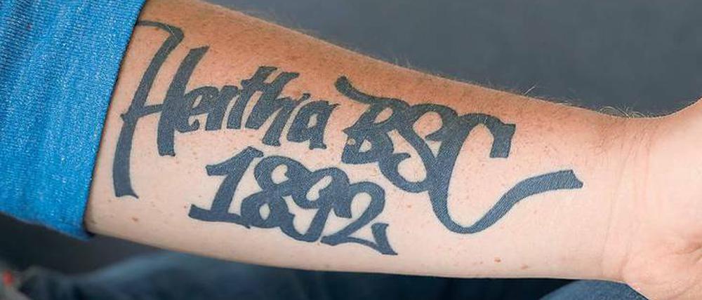 Vom Entwurf bis zur Vollendung. Ein Jahr lang hat Kai-Uwe Heinrich mit Freunden an dem Schriftzug gefeilt, der schließlich auf seinem Unterarm landete – und auch unter dem Hertha-Trikot hervorsticht.