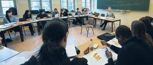 Geflüchtete lernen in einem Volkshochschulkurs in Berlin Mitte Deutsch.