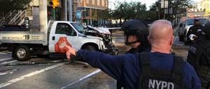 Polizisten stehen in der West Street in New York (USA) vor dem Tatfahrzeug.