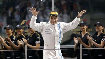 (FILES) This file photo taken on November 23, 2014 shows Williams&amp;apos; Brazilian driver Felipe Massa celebrating on the podium of the Yas Marina circuit in Abu Dhabi on November 23, 2014 after the Abu Dhabi Formula One Grand Prix.Massa is to retire definitively from Formula One at the end of the season he announced on November 4, 2017. The 36-year-old Williams pilot, who won 11 Grand Prix to date, decided to call it a day as his team are yet to confirm their line-up for next season. / AFP PHOTO / Karim SAHIB
