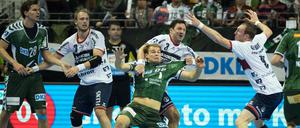 Berlins Paul Drux (M) wird von dem hinter ihm stehenden Tobias Karlsson von Flensburg gehalten. 