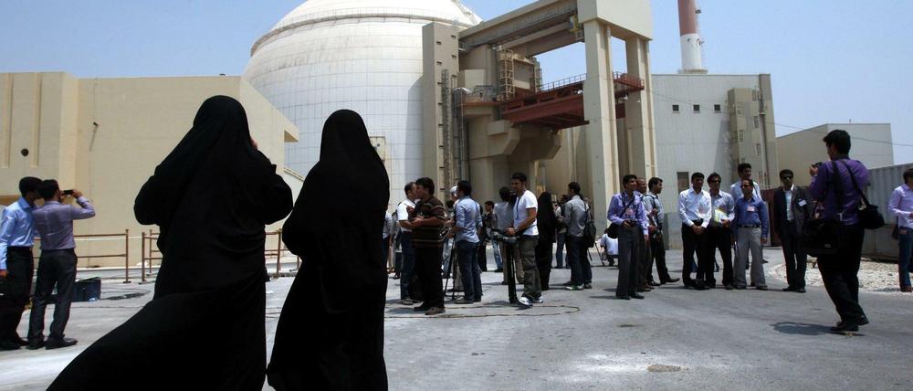 Zwei Sicherheitsbeamtinnen steht vor dem Atomkraftwerk in Buschehr im Iran und beobachten Medienvertretern (im August 2010).