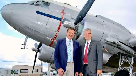 Die Bürgermeister Frank Bröhl (links) und Helmut Kleebank vor einem "Rosinenbomber" aus der Luftbrückenzeit.