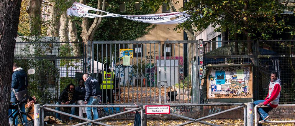 Flüchtlinge und einige Unterstützer sitzen 2014 vor der von Flüchtlingen besetzten ehemaligen Gerhart-Hauptmann-Schule in Kreuzberg.