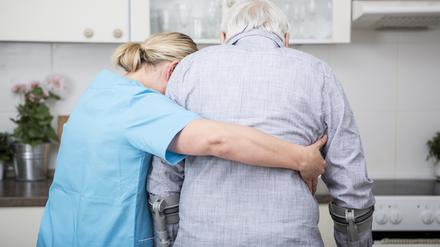 Gereatric nurse supporting week patient