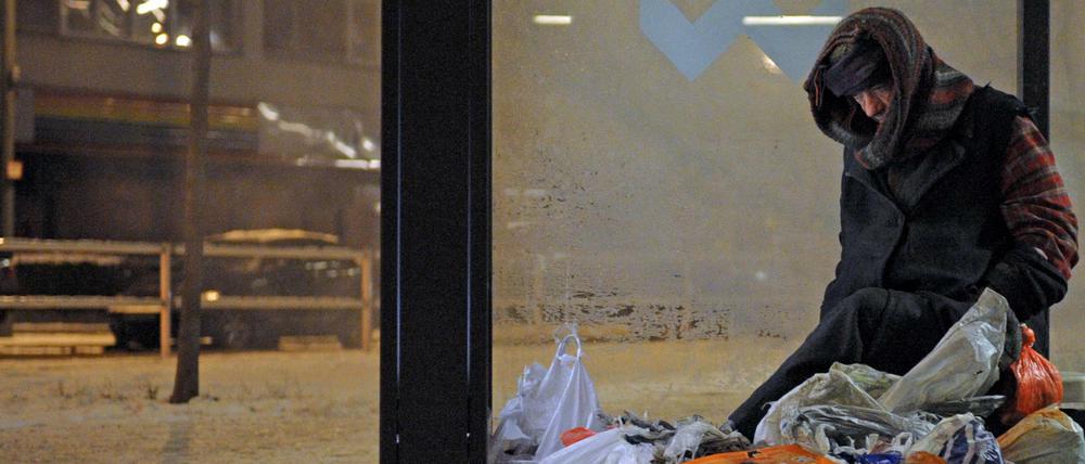 Ein Obdachloser sucht Schutz vor Kälte.