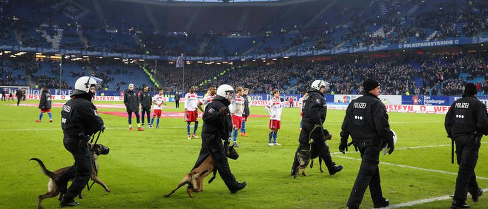 Abgang unter Polizeischutz. Die Hamburger Spieler nach dem 1:2 von Leverkusen.